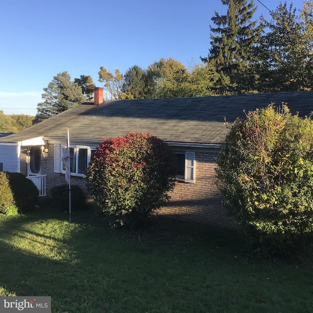 view of side of home featuring a yard