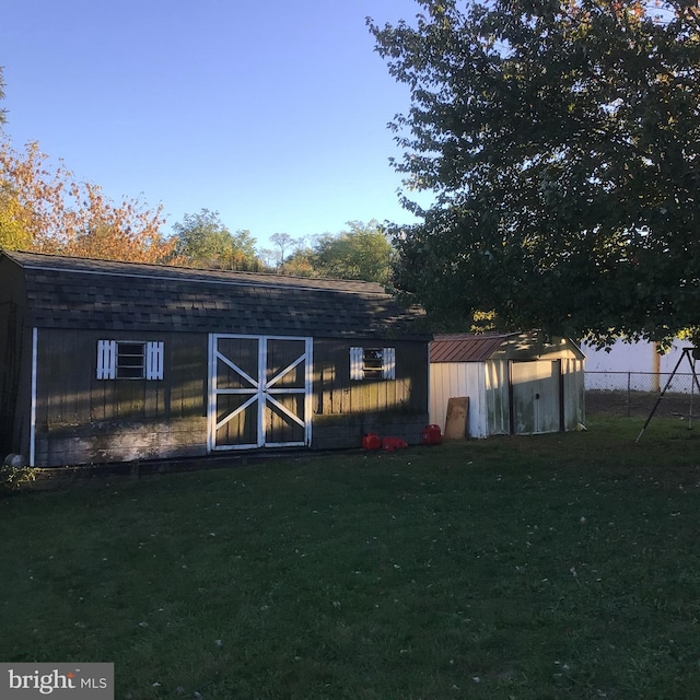 view of outbuilding featuring a lawn