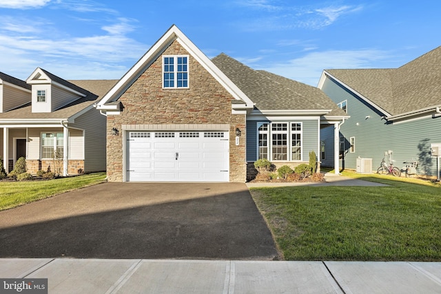 craftsman house featuring a garage and a front lawn