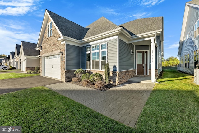 view of front of house featuring a front lawn and a garage