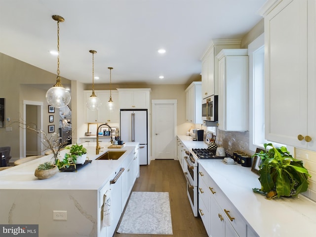 kitchen with white cabinetry, dark wood-type flooring, sink, decorative light fixtures, and white appliances