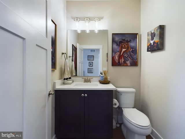 bathroom featuring toilet and vanity