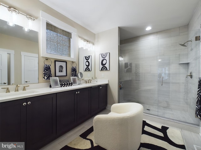 bathroom featuring vanity, a shower with shower door, and tile patterned flooring