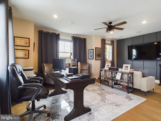 office area with light hardwood / wood-style flooring and ceiling fan