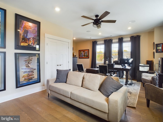 living room featuring ceiling fan and hardwood / wood-style floors