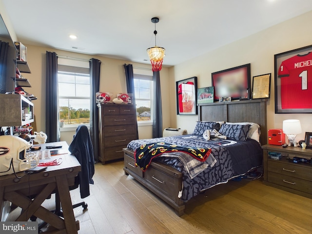 bedroom featuring light hardwood / wood-style flooring and multiple windows