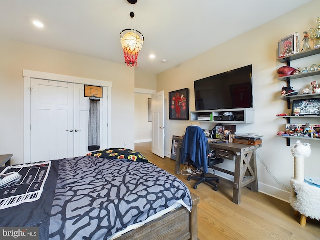 bedroom with a closet and hardwood / wood-style flooring