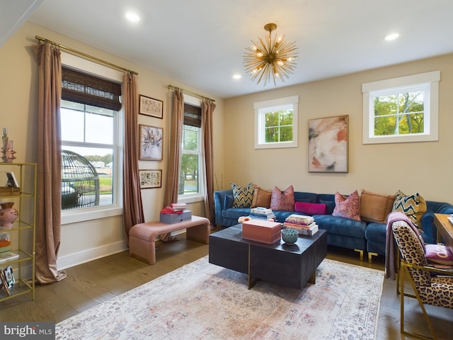 living room featuring an inviting chandelier, dark hardwood / wood-style floors, and plenty of natural light