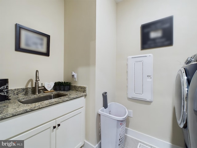 bathroom with vanity, washing machine and dryer, and tile patterned flooring