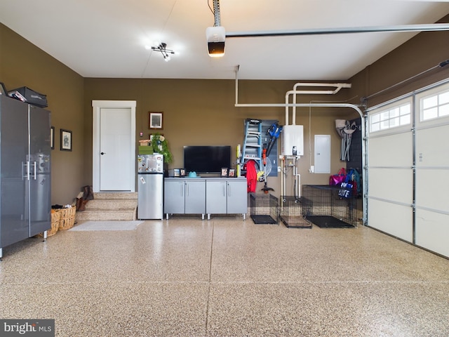 garage with a garage door opener, electric panel, and stainless steel refrigerator