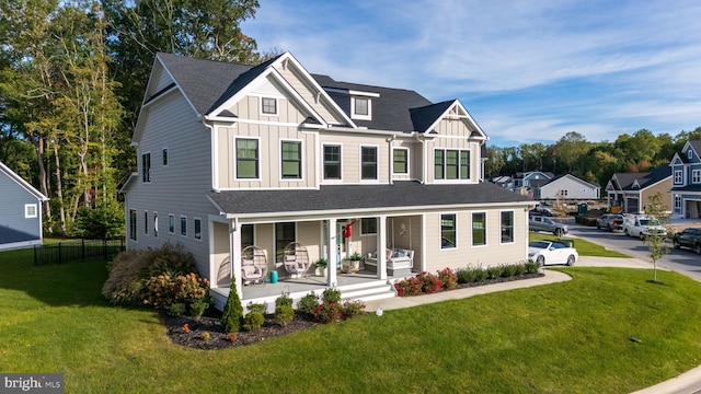 view of front of property with covered porch and a front yard