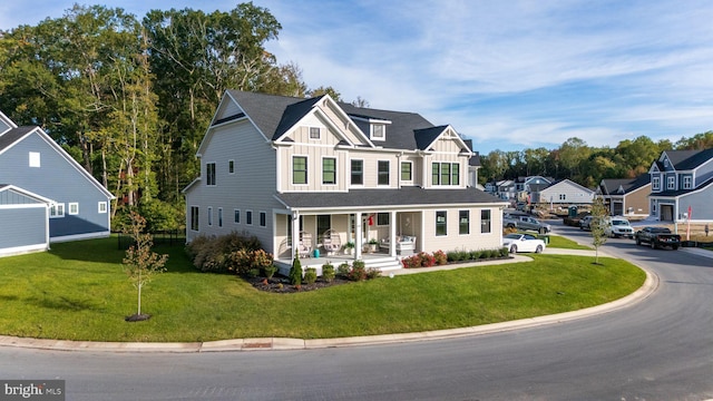 view of front of home with covered porch and a front lawn