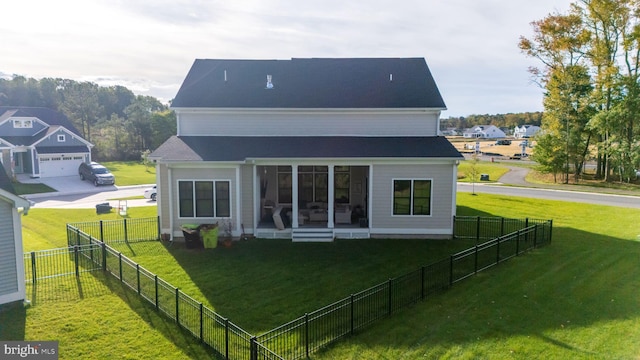 back of house with a yard and a garage