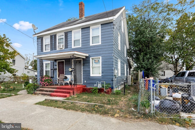 view of front of property with a porch and cooling unit