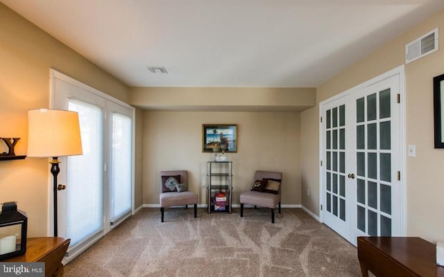 sitting room with light carpet and french doors