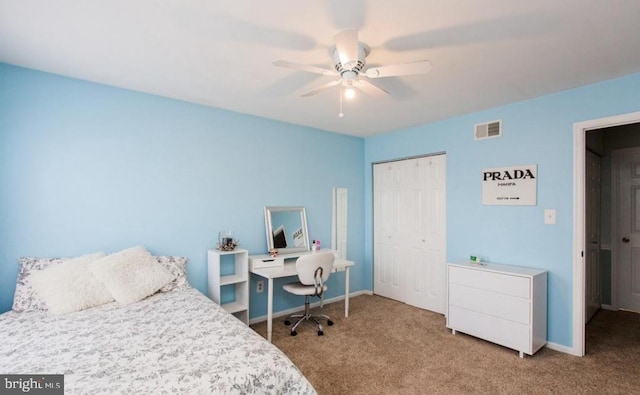 carpeted bedroom featuring ceiling fan and a closet