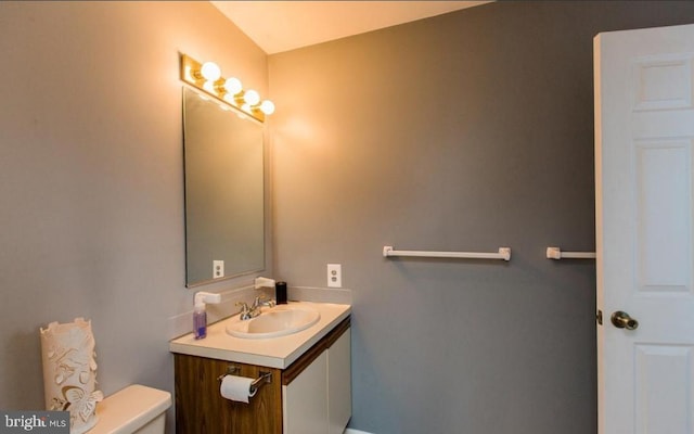 bathroom featuring vanity and toilet