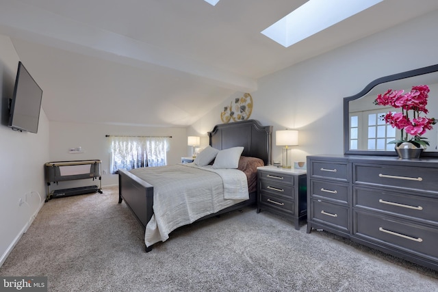 bedroom featuring carpet and lofted ceiling with skylight