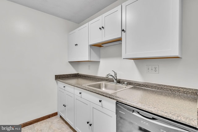 kitchen with stainless steel dishwasher, sink, white cabinets, and light tile patterned floors