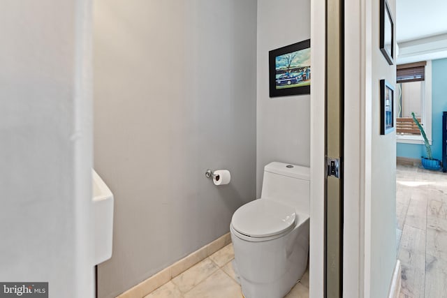 bathroom with hardwood / wood-style flooring and toilet