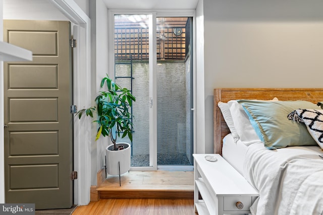 bedroom featuring light hardwood / wood-style floors and access to outside