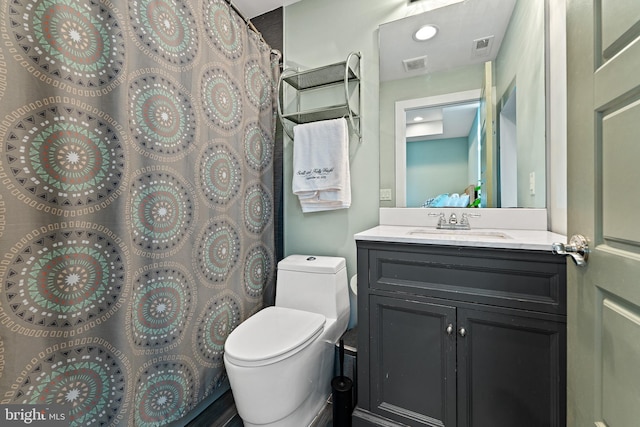 bathroom featuring vanity, curtained shower, and toilet