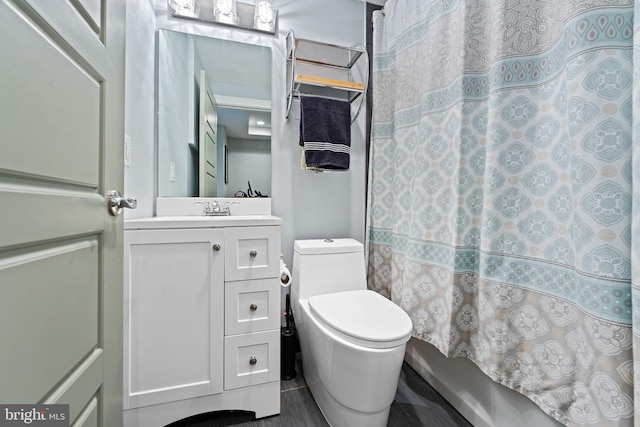 full bathroom featuring vanity, shower / bath combo with shower curtain, and toilet