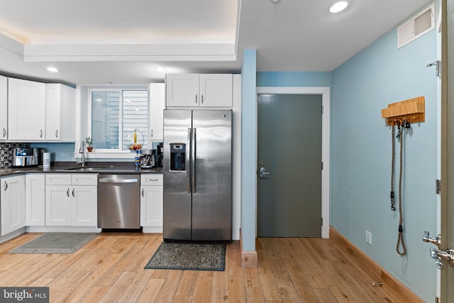 kitchen featuring light hardwood / wood-style flooring, stainless steel appliances, and white cabinets