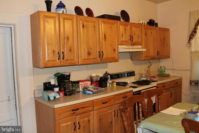 kitchen featuring white range with electric stovetop