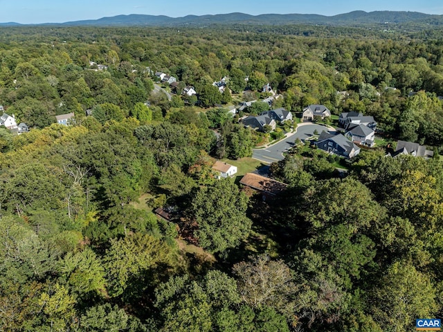 drone / aerial view with a forest view and a mountain view