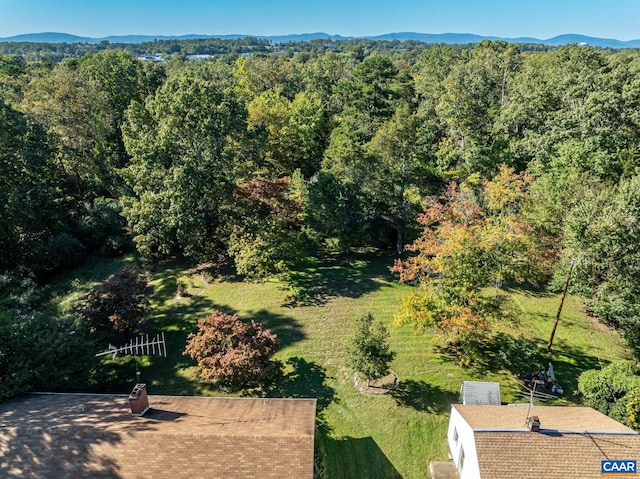 birds eye view of property featuring a wooded view
