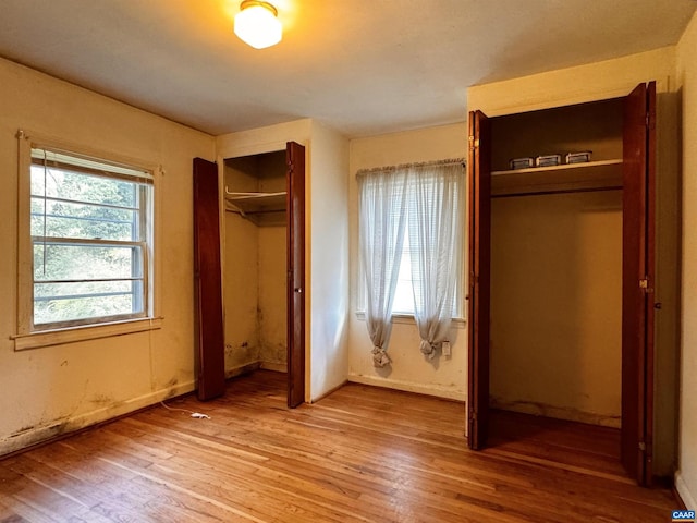 unfurnished bedroom with light wood finished floors and baseboards
