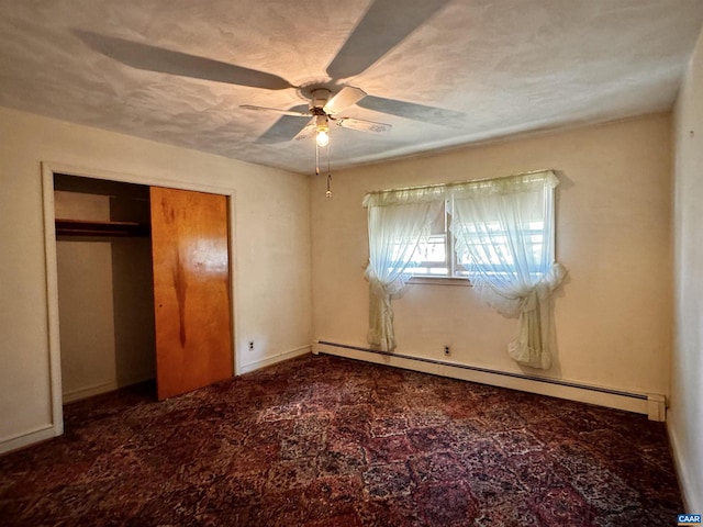 unfurnished bedroom featuring a closet, a baseboard radiator, a ceiling fan, and baseboards