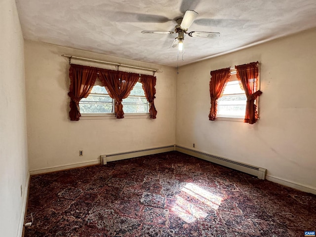 unfurnished room with a baseboard heating unit and ceiling fan