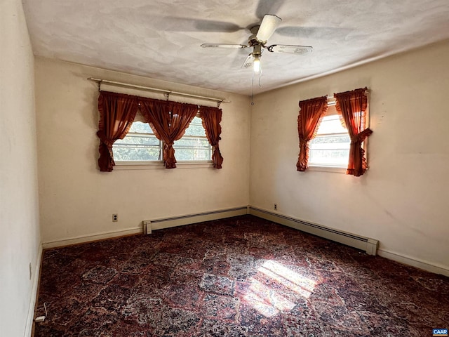 spare room featuring ceiling fan, baseboards, and plenty of natural light