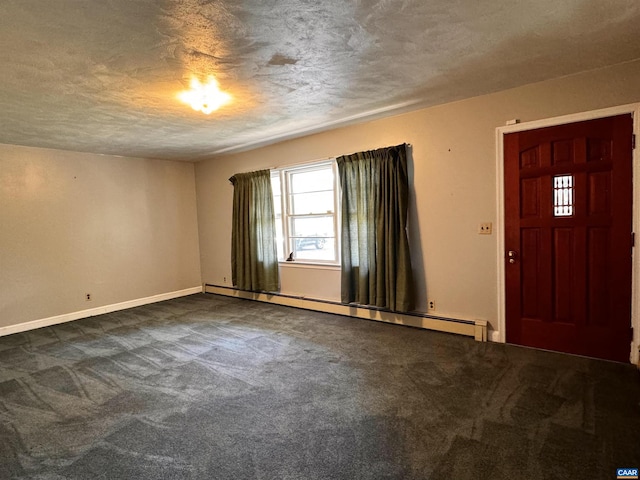 foyer entrance featuring dark carpet, baseboards, a baseboard heating unit, and a textured ceiling