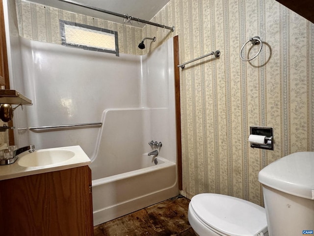 full bath with wallpapered walls, vanity, shower / bathing tub combination, and toilet