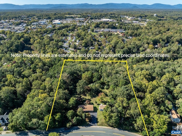bird's eye view featuring a wooded view and a mountain view