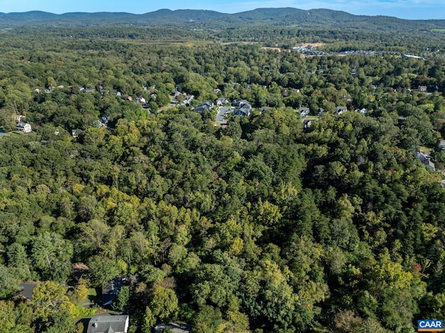 drone / aerial view with a forest view and a mountain view