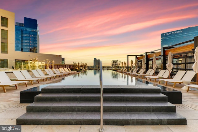 pool at dusk with a water view