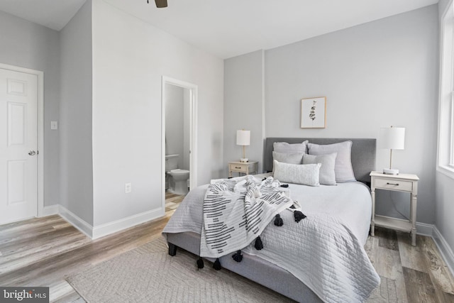 bedroom featuring hardwood / wood-style floors, ensuite bathroom, and ceiling fan