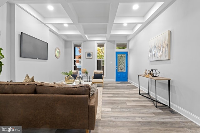 living room with light hardwood / wood-style floors, beamed ceiling, and coffered ceiling