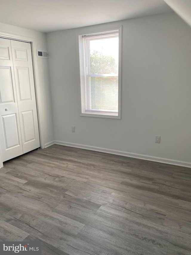 unfurnished bedroom featuring a closet and light wood-type flooring