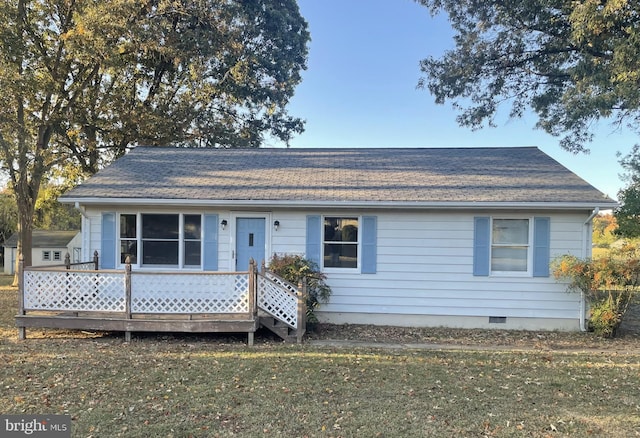 view of front facade with a deck and a front lawn