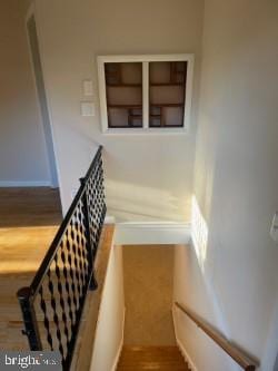 staircase with hardwood / wood-style flooring