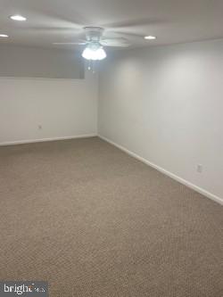 carpeted empty room with ceiling fan