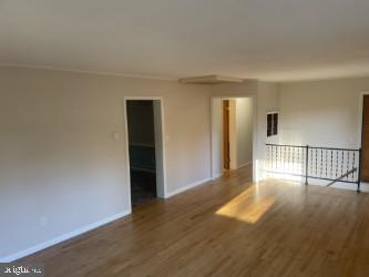 empty room featuring wood-type flooring