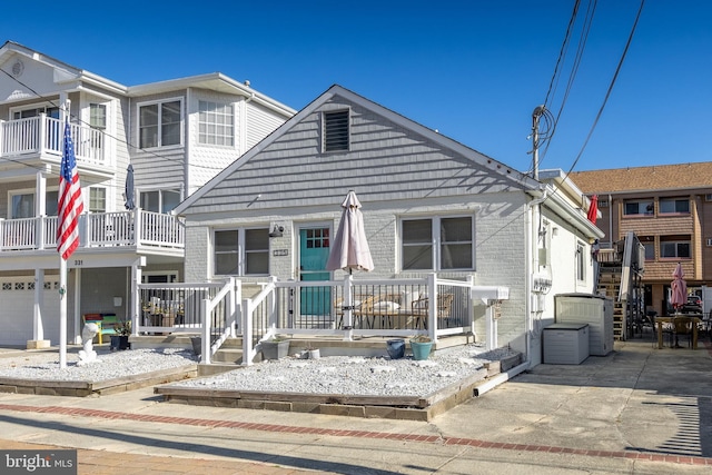 view of property with a garage and a balcony