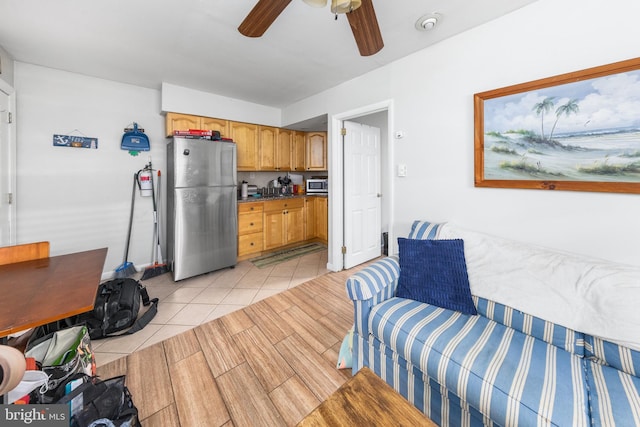 tiled living room with ceiling fan