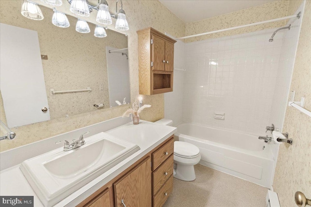 full bathroom with toilet, tiled shower / bath combo, and vanity